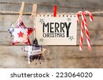 Merry christmas inscription. Merry Christmas inscription on checkered paper attach to rope 