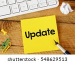 Update/Update sticker with marketing plan inscription over computer keyboard