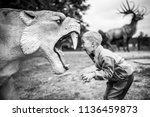 Boy shouting at the artificial saber-toothed tiger