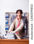 Small photo of Crazy young man in straitjacket at the office