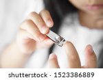 Small photo of asian child cute or kid girl long nails and learn cut fingernails by help oneself and nail clipper on 5 years old and white tone background