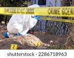 Small photo of Crime scene investigation. Forensic science specialist working on human remains identification.