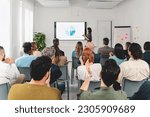 Small photo of In a spacious office room, a businesswoman presents a SWOT analysis on a large screen. The diverse audience, viewed from the back, is clapping their hands in appreciation.