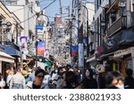 Small photo of Tokyo, Japan - April 09, 2023: Street view of Yanaka Ginza with unknown people, a traditional shopping street in Yanaka district, which was spared during WW2 and therefore shows the charm of old Japan