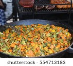 large pot with carrots broccoli peppers and other vegetables cooked