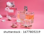 lady set with cosmetics and flowers around pink background. 