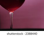 red wine in glass on light purple background