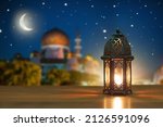 Small photo of Ramadan Kareem greeting. Islamic lantern on night sky with crescent moon and stars. End of fasting. Hari Raya card. Eid al-Fitr decoration. Breaking of holy fast day. Muslim holiday.