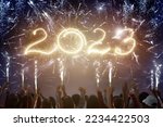 Small photo of Happy new year. Family watching fireworks. Parents and kids celebrate new 2023 year. Winter holiday party. Outdoor fun. Children, mother and father with sparkler watch firework show.