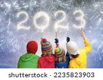 Small photo of Happy new year. Family watching fireworks. Parents and kids celebrate new 2023 year. Winter holiday party. Outdoor fun. Children, mother and father with sparkler watch firework show.