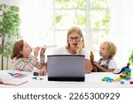 Small photo of Mother working from home with kids on summer holiday. Children make noise and disturb woman at work. Homeschooling and freelance job. Boy and girl playing making loud noise.