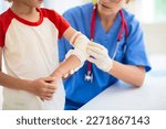 Small photo of Child with arm injury at trauma and emergency care. Kid with elbow cast at health clinic. Doctor checking x-ray of injured little boy. Kids hospital.