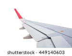 Wing of airplane flying on white background