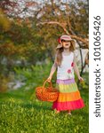 Small photo of Cute little girl in maxi skirl and hat walking in the garden. Country style