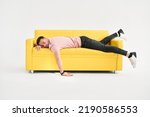 Funny frustrated exhausted man sleeping on sofa over white background. Rest, overworked concept