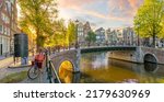 Small photo of Soul of Amsterdam. Early morning in Amsterdam. Old houses, bridges, bicycles and the famous Amsterdam toilet. Panoramic view with all the sights of Amsterdam. Holland, Netherlands, Europe.