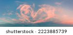 Small photo of Magic real heart made from clouds in the sunset sky. Pink light heart shaped clouds. Love. Panoramic sky for Valentine's Day, Wedding, Mother's Day. Holidays of love and tenderness