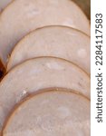 Small photo of Low-quality chicken ham during cooking, lackluster sausage using chicken meat