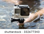 Hands on water with camera GoPro