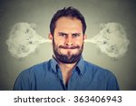 Closeup portrait of angry young man, blowing steam coming out of ears, about to have nervous atomic breakdown isolated gray background. Negative human emotions facial expression feelings attitude
