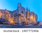 Palace of the Popes, once a fortress and palace, one of the largest and most important medieval Gothic buildings in Europe, during evening blue hour, Avignon, southern France