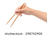 Person 's right hand using bamboo chopsticks against white background