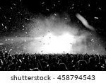 Black and White Confetti Silhouette Crowd at a Music Festival - Backlit. 