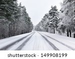 Snowy street through forest