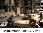 Small photo of Distribution warehouse background, commercial shipping order boxes for dispatching on stockroom table, post courier delivery package, dropshipping commerce retail store shipment storage concept.