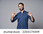 Small photo of Smiling proud confident indian professional business man standing isolated on gray background pointing at himself bragging as choose me concept. Human resources, self-confidence, ego. Portrait.