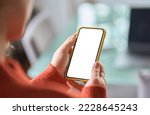 Small photo of Over shoulder view of woman holding smartphone with white blank mock up cellular screen mobile applications using cell phone. Cellphone display mock up for advertising apps concept.
