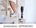 Small photo of Man amputee with prosthetic leg disability on above knee transfemoral leg prosthesis artificial device stands on feet on stairs, close up. People with amputation disabilities everyday life.