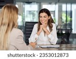 Small photo of Happy mature professional business woman executive hr manager having job interview or business discussion with female applicant or colleague sitting at workplace in corporate office meeting.