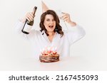 Small photo of a lilt woman with champagne and a birthday cake with candles. traditional sweet treat and wish-making for a birthday.