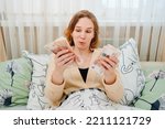 Small photo of a women count a stack of money of a banknotes of 5000 rubles in bed. the concept of depreciation of the ruble. earnings online in Russia.