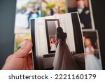 printed wedding photos on a black background and in hand. the concept of preserving the memory of an important event, the services of a professional photographer for the celebration and typography.