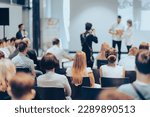 Small photo of Speaker giving a talk in conference hall at business event. Rear view of unrecognizable people in audience at the conference hall. Business and entrepreneurship concept.