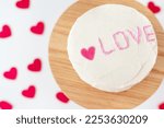Bento cake with the inscription Love and hearts. A small Korean cake for one person. Selective focus, noise. A cute dessert gift for a loved one for any holiday. Valentine's Day