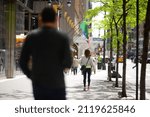 Small photo of NEW YORK , USA - MAY 11 2021: crowd of people walking down the street on a sunny day in NYC, America. The bustling life of a big city
