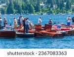 Small photo of Lake Arrowhead, CA - 9 June 2012: Fans review the gathering of classic mahogany runabout boats at the Antique and Classic Wooden Boat Show near Lake Arrowhead Village.