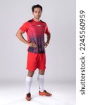 Small photo of Male footballer wearing athletic uniform and shoes, standing still, confident posture according to athlete personality on a white background in the studio.