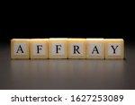 Small photo of The word AFFRAY written on wooden cubes isolated on a black background...