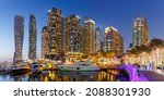 Small photo of Dubai Marina and Harbour skyline architecture wealth luxury travel with yacht boat at night panorama in United Arab Emirates modern