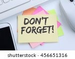 Don't forget date meeting remind reminder notepaper business concept desk computer keyboard