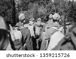 Re-enactors Dressed As World War II Russian Soviet Red Army Soldiers Marching Through Forest. Photo In Black And White Colors. Soldier Of WWII WW2 Times.