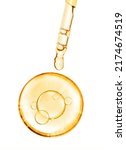 Small photo of gold miracle yellow bubble vitamin oil or serum isolated on white background with laboratory glass pipette on white background. Beauty and skin care
