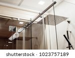 Small photo of Metal structure of the upper fasteners and rollers for the sliding glass door in the shower enclosure conjugated with the glass door to the sauna view in the interior