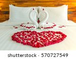 Beautiful hotel for honeymoon sweet.Swan couple put on honeymoon bed look like heart shape with rose petals for honeymoon lover.The staff hotel put yellow lighting in the room make romantic feeling.

