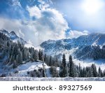 Winter Snowy Mountains valley with fog and sun in Chumbulak, Almaty, Kazakhstan