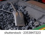 Small photo of Coal scuttle on a pile of coals on a steam train